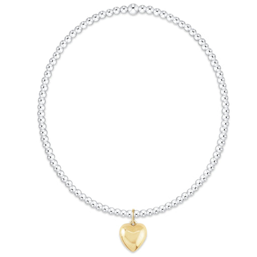 Mixed‑metal beaded bracelet with 2mm sterling silver beads and a small gold charm, hand‑strung on elastic for everyday wear.