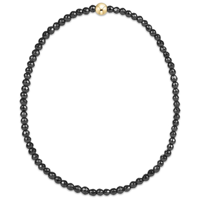 enewton design faceted hematite bead bracelet with single gold accent bead.