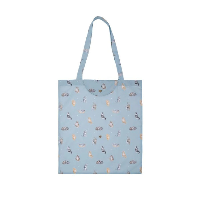 A blue tote bag featuring a playful cat design on the front.