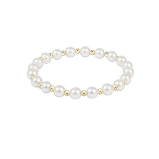 Pearl bracelet with gold accents on a white background