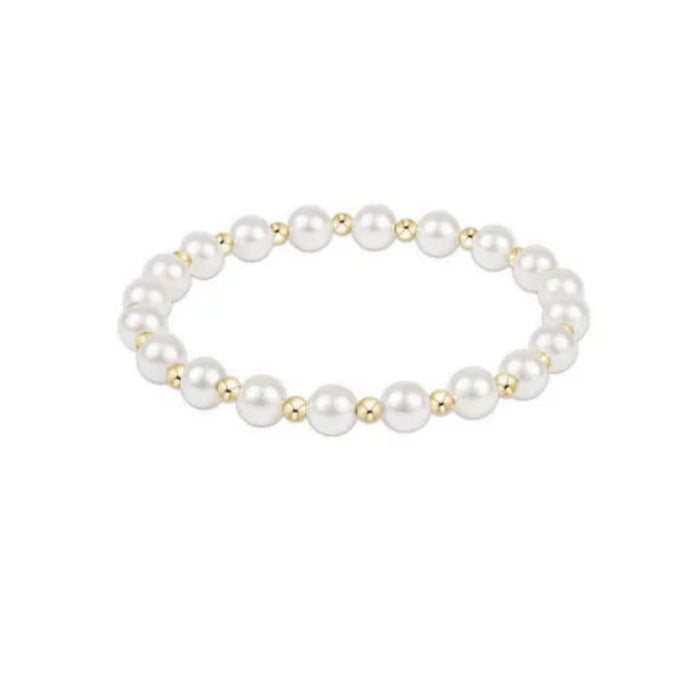 Pearl bracelet with gold accents on a white background