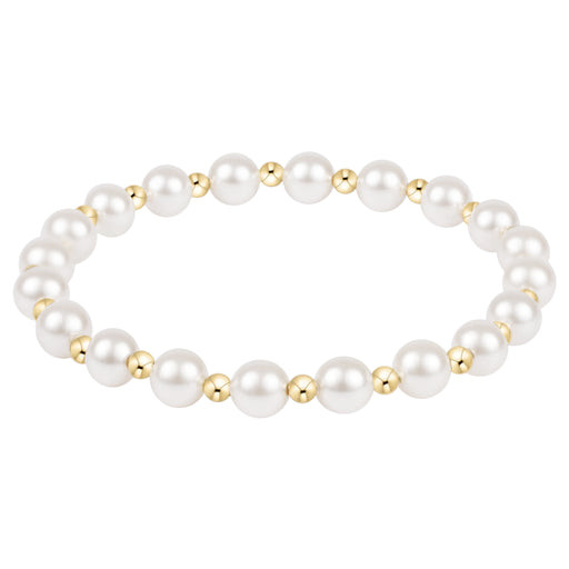 Pearl bracelet with gold accents on a white background