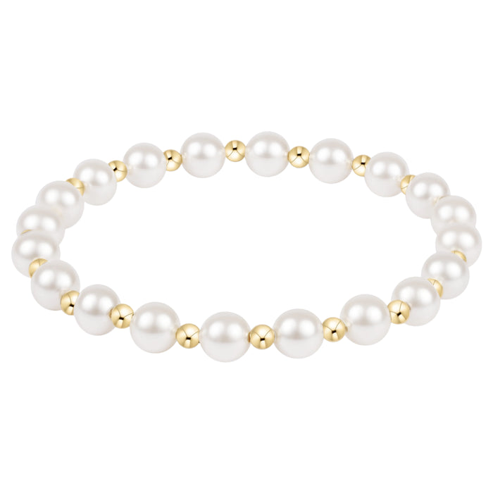 Pearl bracelet with gold accents on a white background