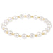 Pearl bracelet with gold accents on a white background