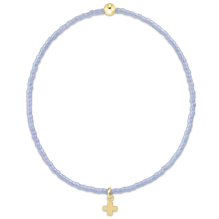 "This beautifully crafted pink beaded bracelet featuring a delicate gold-tone cross charm"