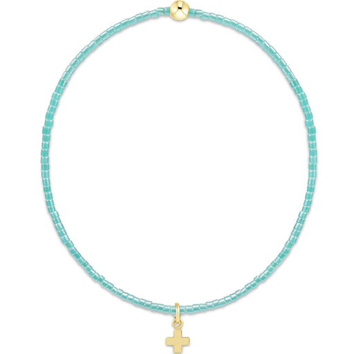 "Designed with soft pink seed beads and accented by a polished gold bead, this bracelet offers a meaningful yet fashionable look."