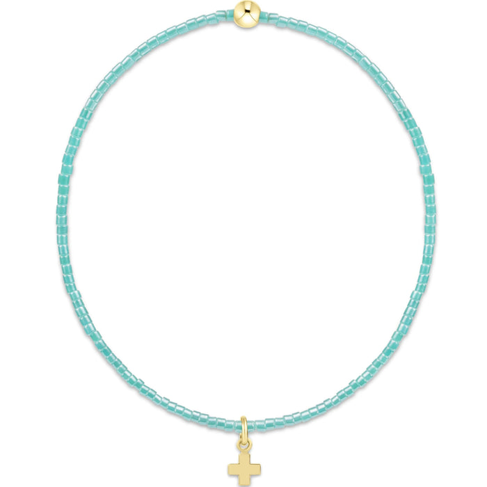 "Designed with soft pink seed beads and accented by a polished gold bead, this bracelet offers a meaningful yet fashionable look."