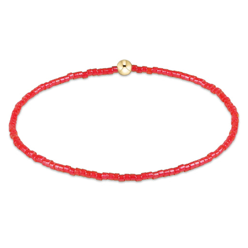 "Hand beaded on high performance elastic for a slight stretch to easily roll on and off your wrist"