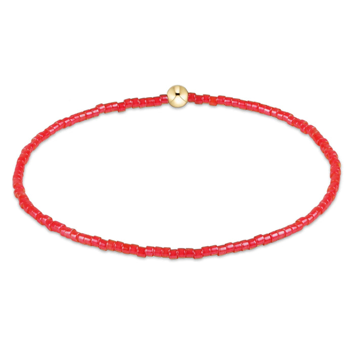 "Hand beaded on high performance elastic for a slight stretch to easily roll on and off your wrist"