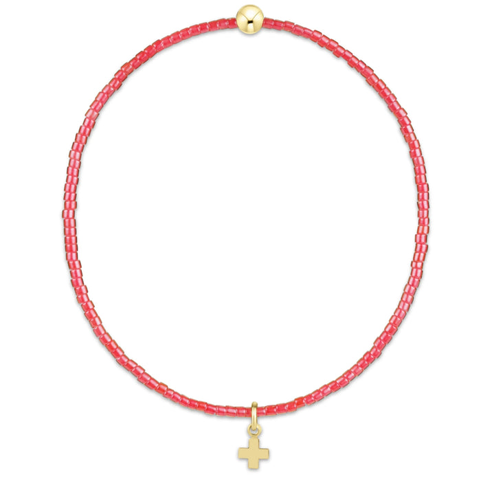 "Designed with soft pink seed beads and accented by a polished gold bead, this bracelet offers a meaningful yet fashionable look."