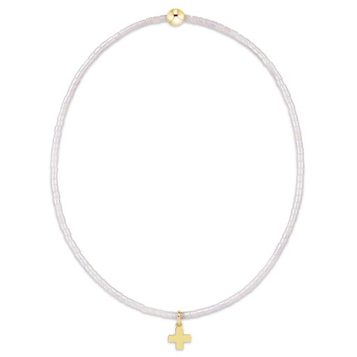 "This beautifully crafted pink beaded bracelet featuring a delicate gold-tone cross charm."