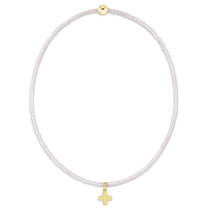 "This beautifully crafted pink beaded bracelet featuring a delicate gold-tone cross charm."
