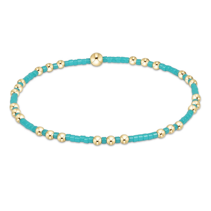"Hand beaded on high performance elastic for a slight stretch to easily roll on and off your wrist"
