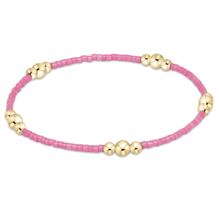 Featuring a harmonious blend of soft seed beads and polished gold-tone accent beads.
