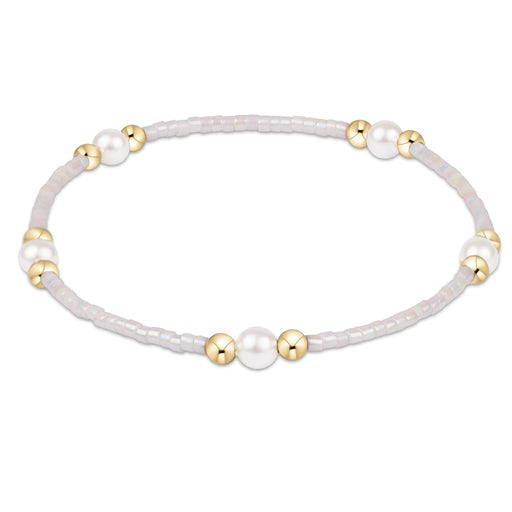 "Featuring soft pastel seed beads, luminous pearl accents, and polished gold-tone spacer beads. "
