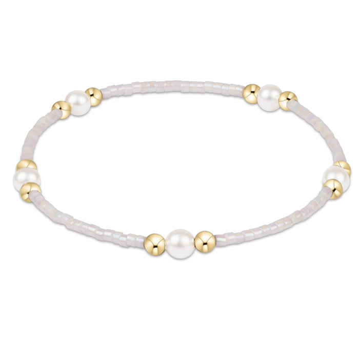 "Featuring soft pastel seed beads, luminous pearl accents, and polished gold-tone spacer beads. "