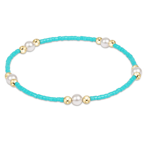 "Featuring soft pastel seed beads, luminous pearl accents, and polished gold-tone spacer beads."