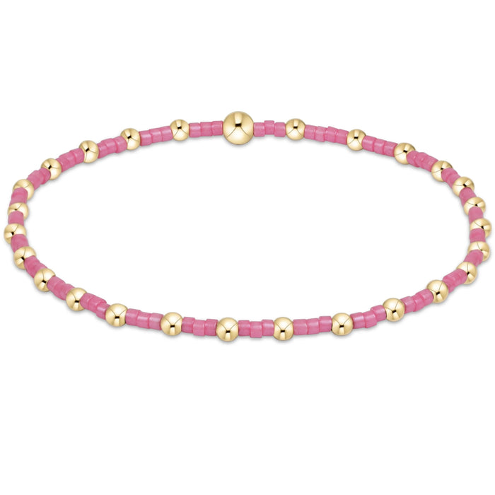 Featuring vibrant pink seed beads accented with polished gold-tone beads