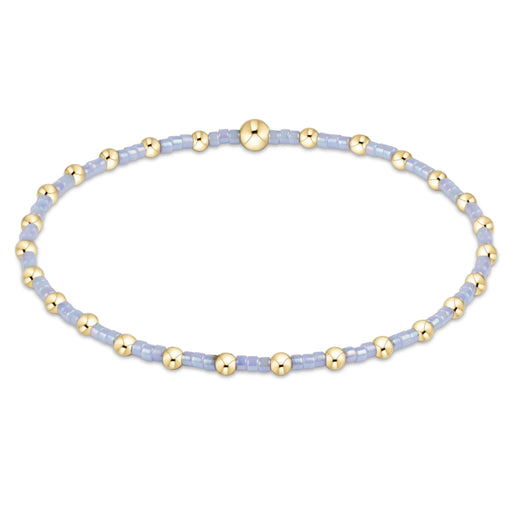 "Featuring vibrant pink seed beads accented with polished gold-tone beads, this bracelet offers the perfect blend of fun and elegance"