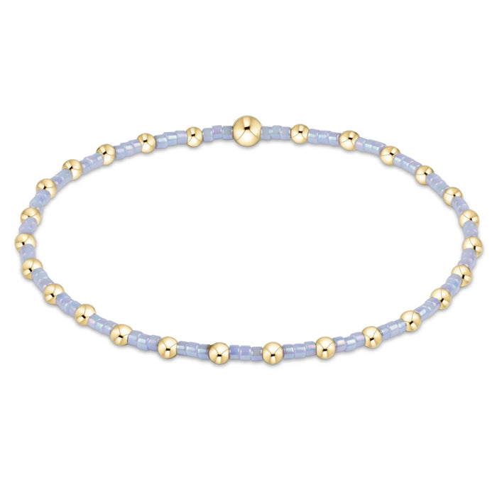 "Featuring vibrant pink seed beads accented with polished gold-tone beads, this bracelet offers the perfect blend of fun and elegance"