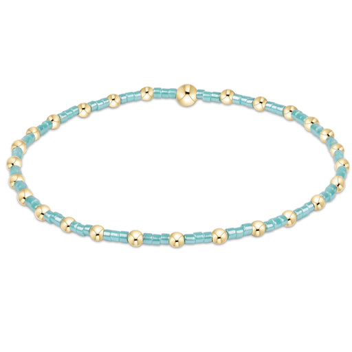 "Hand beaded on high performance elastic for a slight stretch to easily roll on and off your wrist"