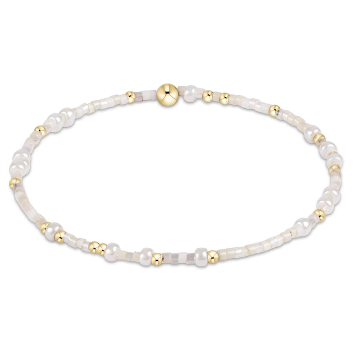 "Hand beaded on high performance elastic for a slight stretch to easily roll on and off your wrist"