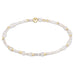"Hand beaded on high performance elastic for a slight stretch to easily roll on and off your wrist"