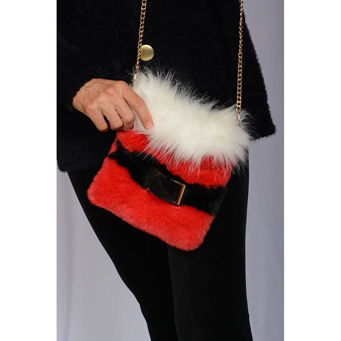 Red fur handbag with white fur top held by a person wearing black clothing.
