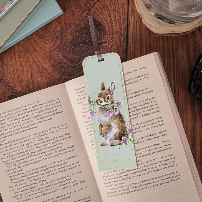 A charming bookmark illustrated with a bunny and delicate purple floral designs.