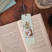 A charming bookmark illustrated with a bunny and delicate purple floral designs.