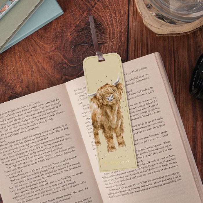 A whimsical bookmark adorned with a cheerful cow illustration, ideal for marking pages in your favorite books.
