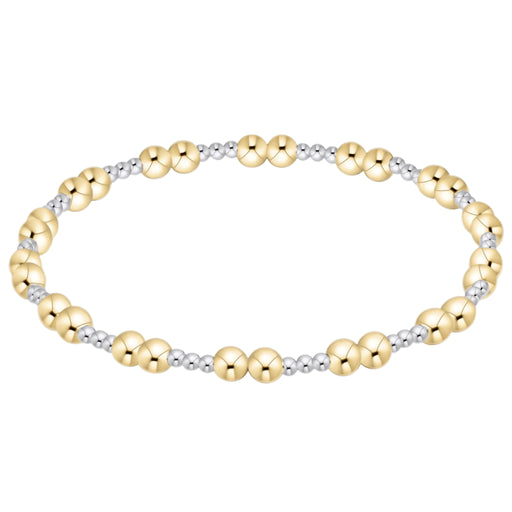 Two-tone gold and silver beaded bracelet on a white background