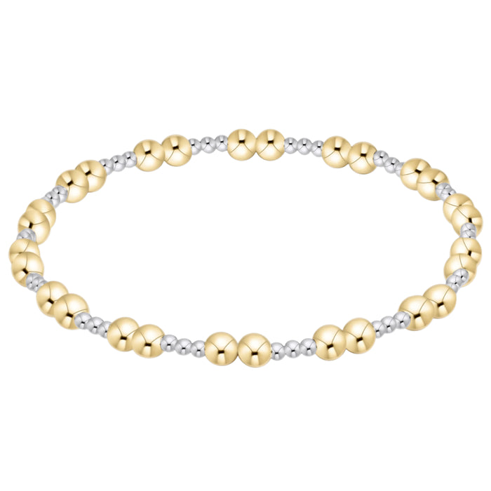 Two-tone gold and silver beaded bracelet on a white background