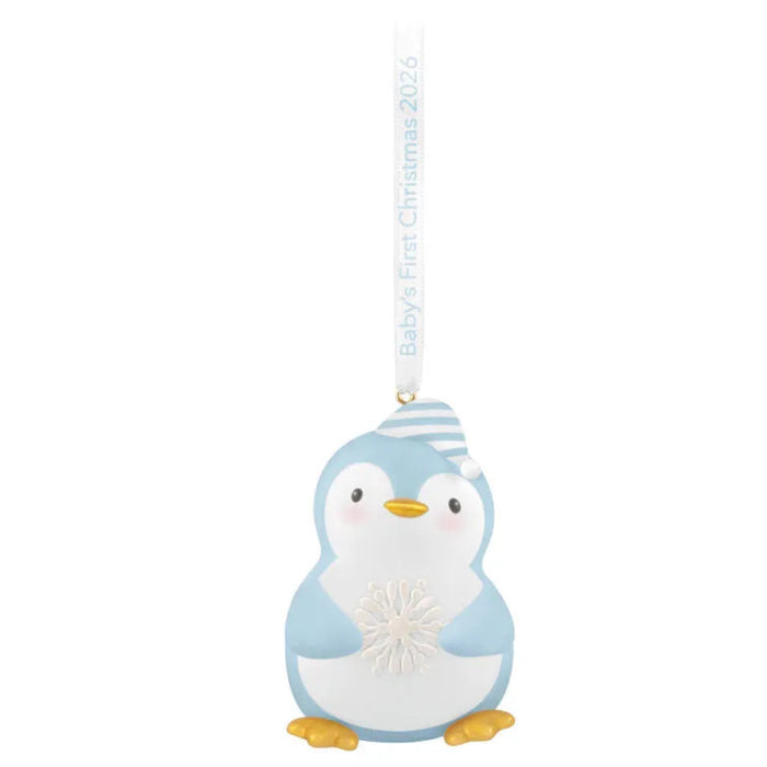 Decorative penguin ornament with a baby hat on a white background