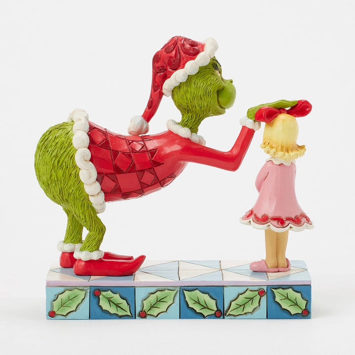 Back view of Cindy Lou with the Grinch leaning over in a Santa suit.