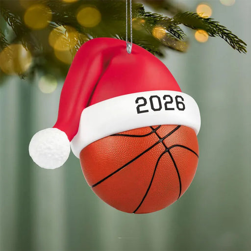 2026 Hallmark basketball Christmas tree ornament hanging on pine branch with festive golden lights