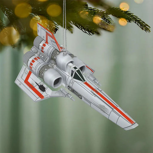 White and orange Colonial Viper ornament hanging on pine Christmas tree branch