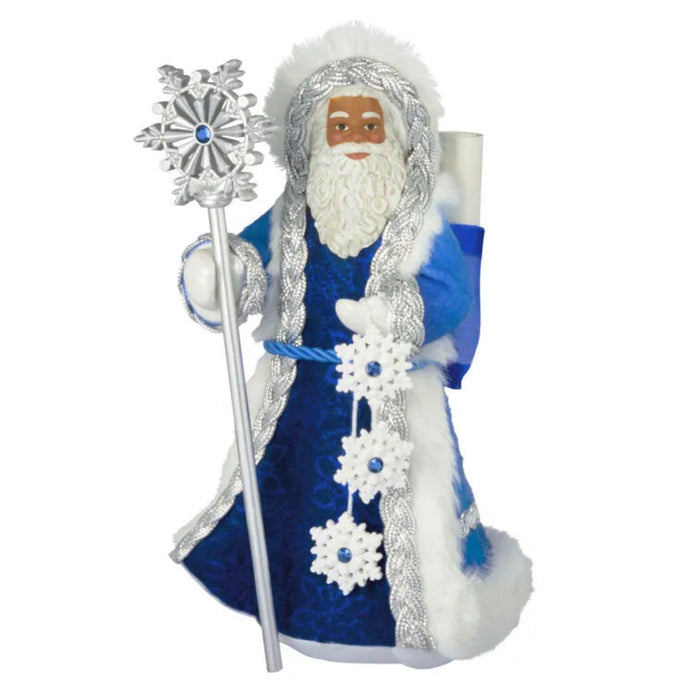 Decorative figure of a bearded man in blue and white attire with a snowflake staff on a white background