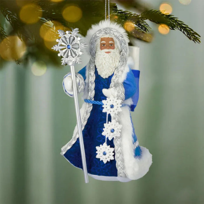 Decorative ornament of a character in a blue outfit with a staff, hanging on a tree branch.