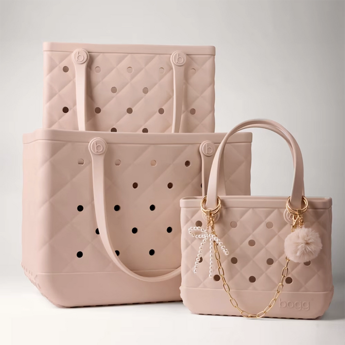 Freshly Pressed Linen faux fur pouf keychain with gold hardware attached to a quiltedFreshly Pressed Linen Bogg Bag as a stylish bag charm