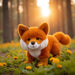 Bukowski Clever Fox Plush standing in a forest setting with flowers and sunlight, showcasing woodland fox design