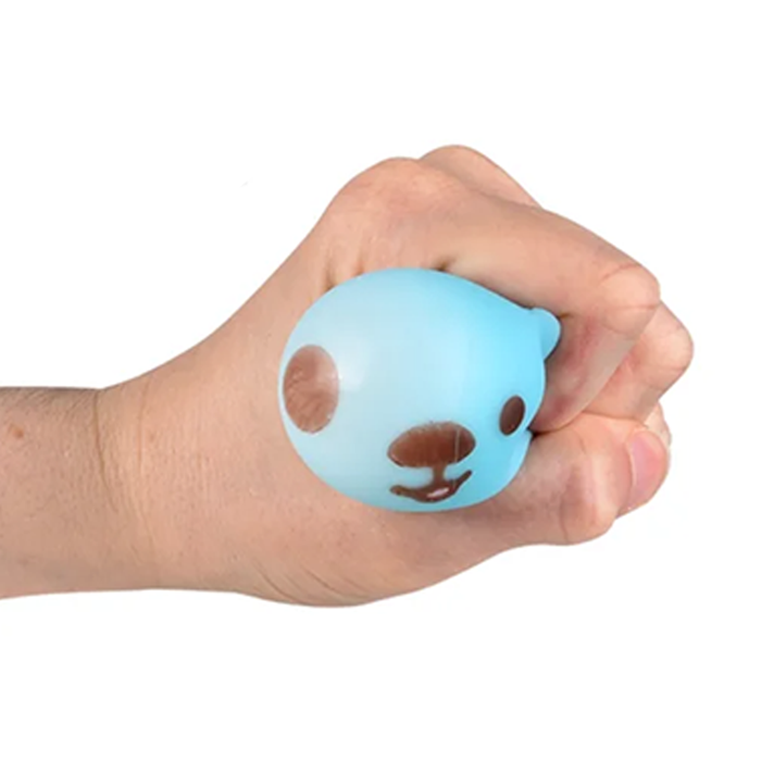 Hand holding a blue squishy ball with a face design on a white background
