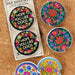 A pair of car magnets showcasing intricate floral designs in bright hues.