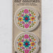 Two car coasters featuring vibrant, colorful flowers on a light background.