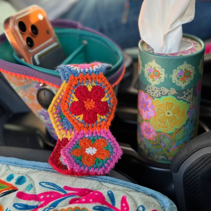 A car's dashboard featuring a tissue holder, providing easy access to tissues while driving.