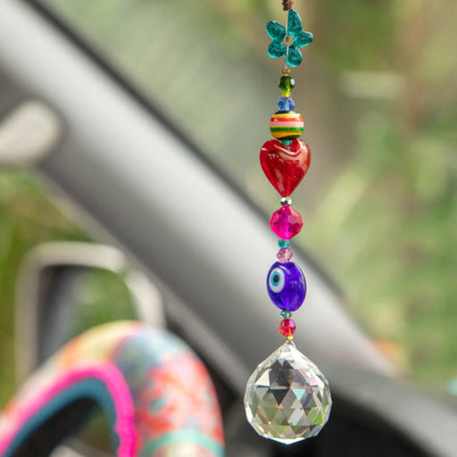 A pink and purple bracelet featuring a delicate silver chain.