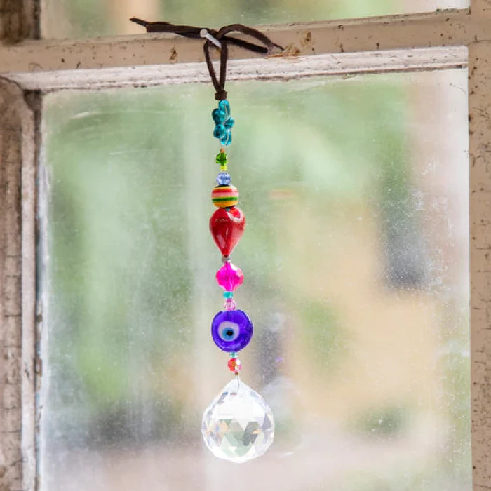 A stylish bracelet with pink and purple beads attached to a silver chain.