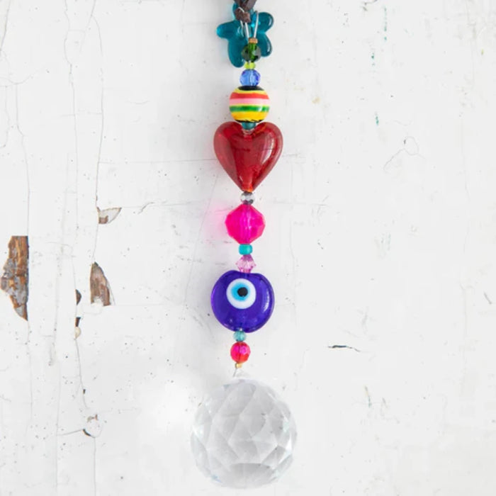 A vibrant pink and purple bracelet complemented by a silver chain.