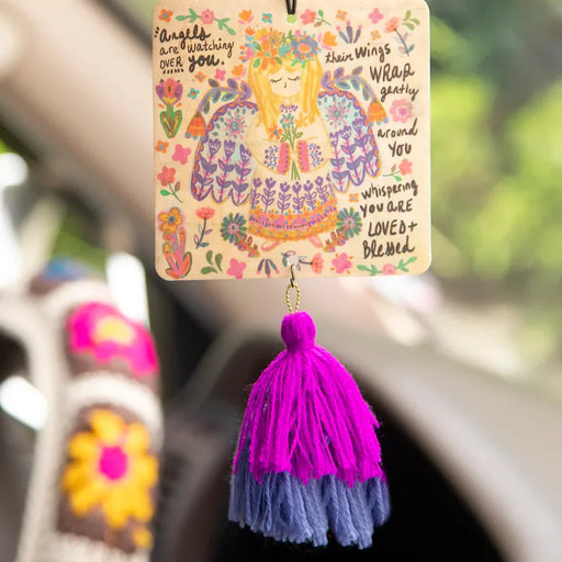 A wooden air freshener featuring a colorful design and a decorative tassel.