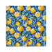 A blue and yellow patterned towel featuring vibrant oranges scattered across its surface.
